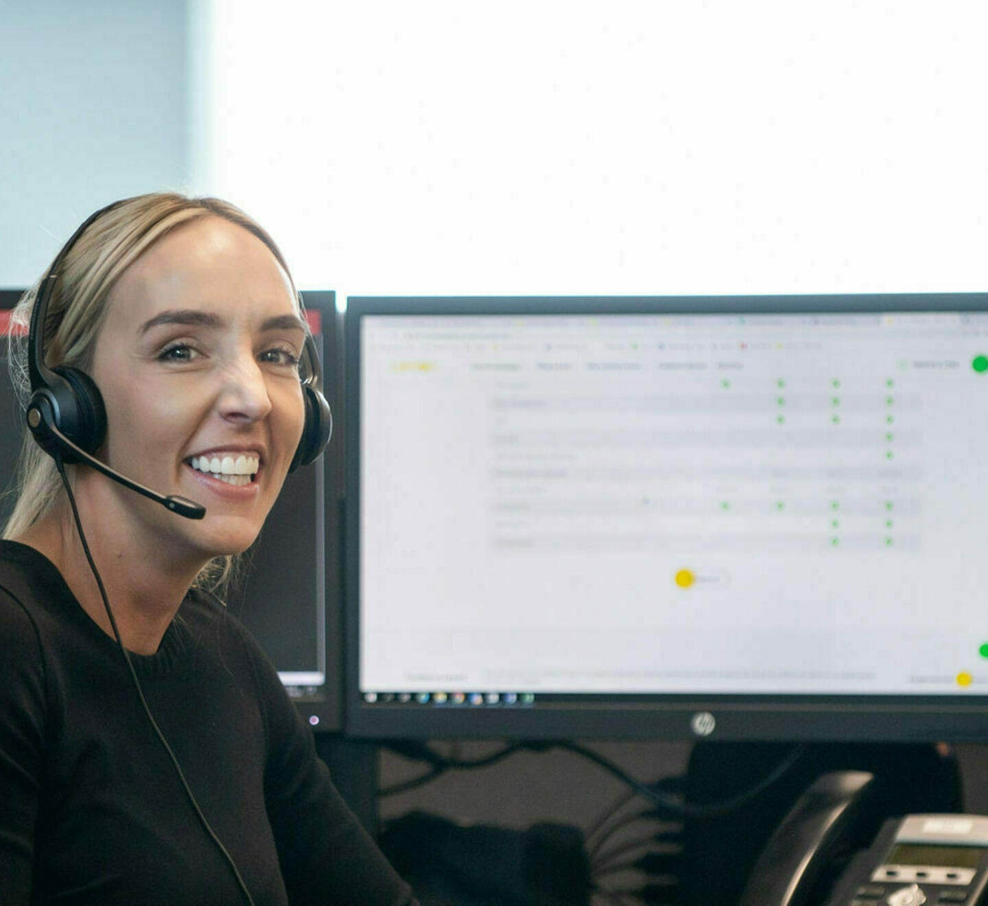 alt="smiling contact centre operator wearing headset"