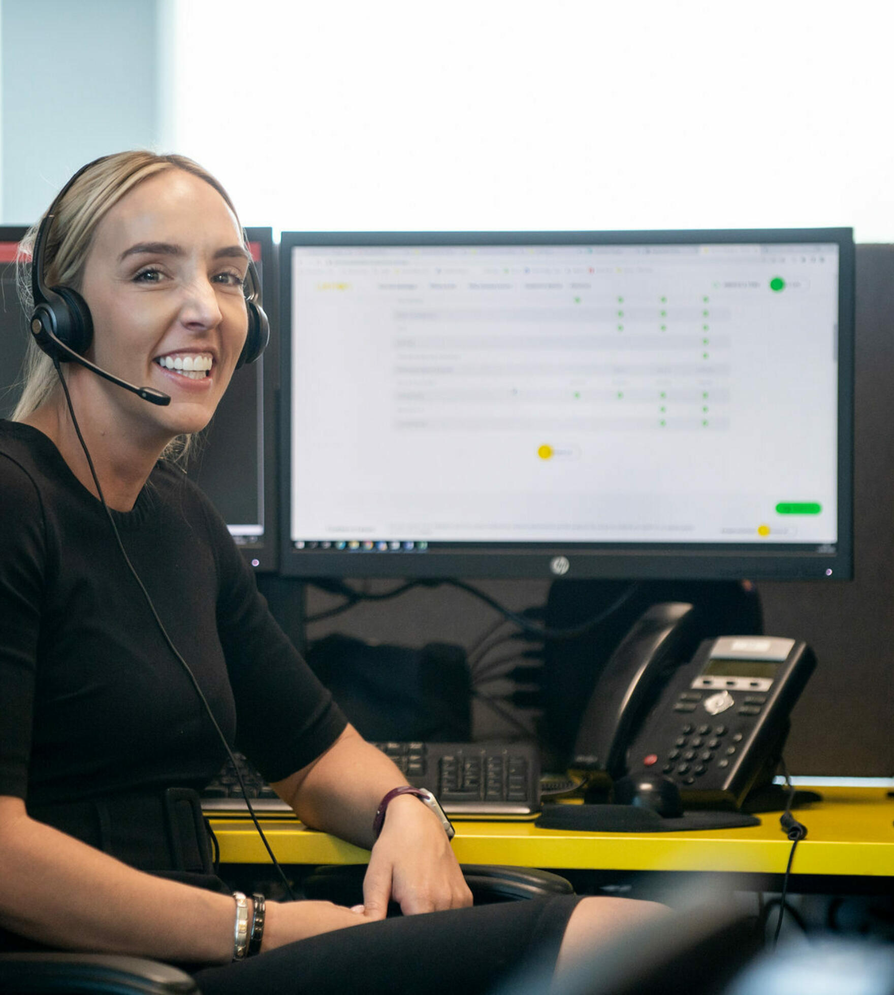 alt="Lemon Contact Centre operator smiling looking at camera wearing heatset"