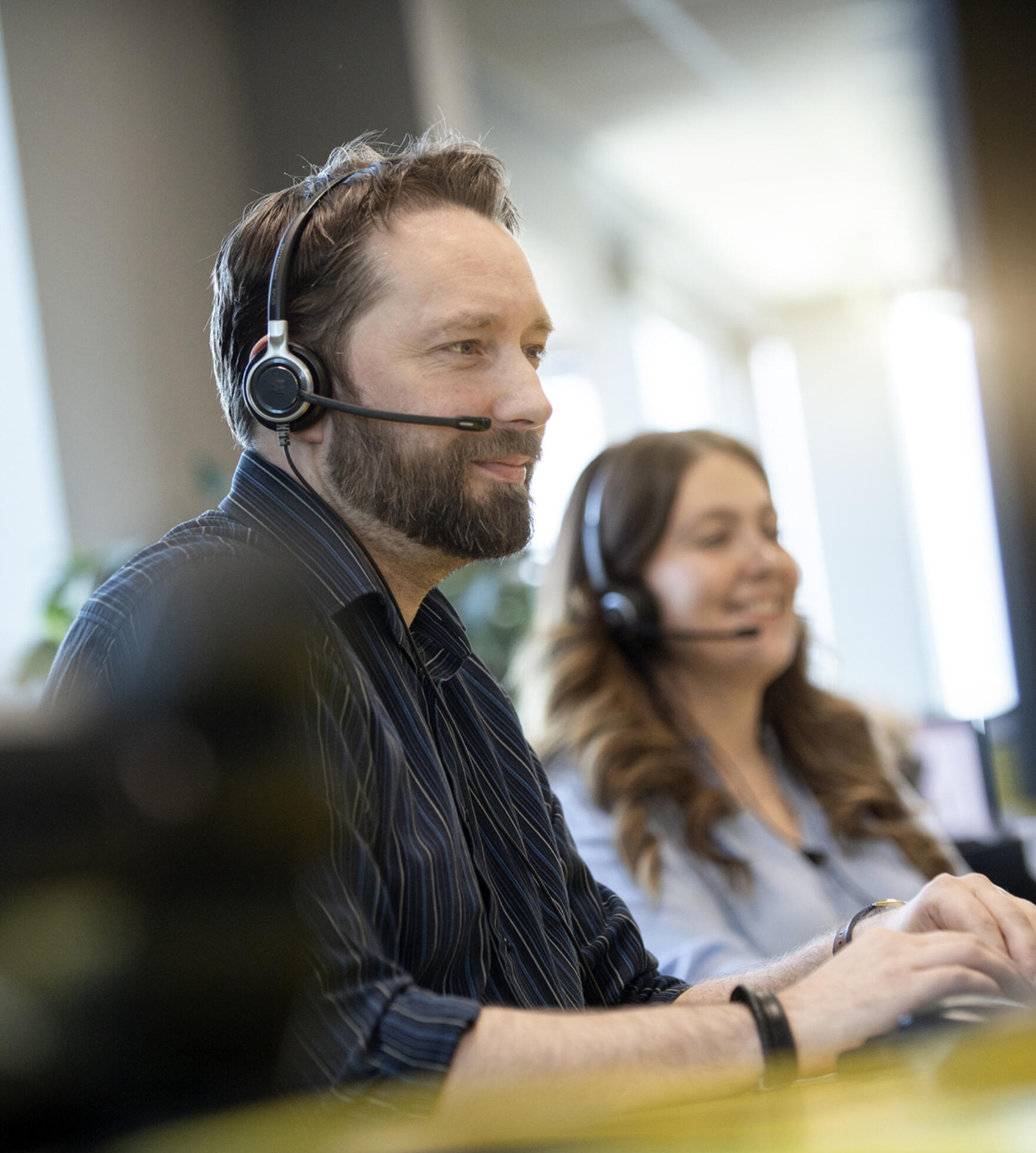 alt="two Lemon Contact Centre operators taking calls"