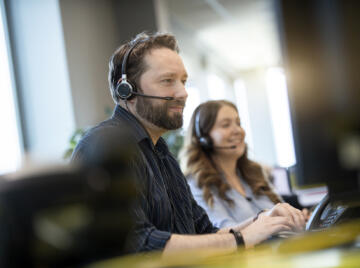 alt="two Lemon Contact Centre operators taking calls"