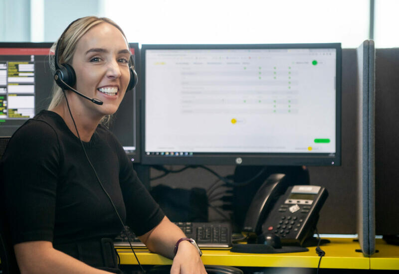 alt="Lemon Contact Centre operator smiling looking at camera wearing heatset"